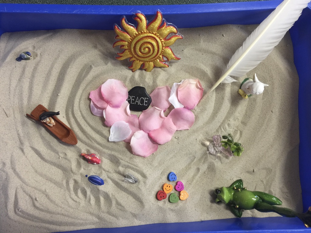 Sand tray and miniatures used in sandplay therapy
